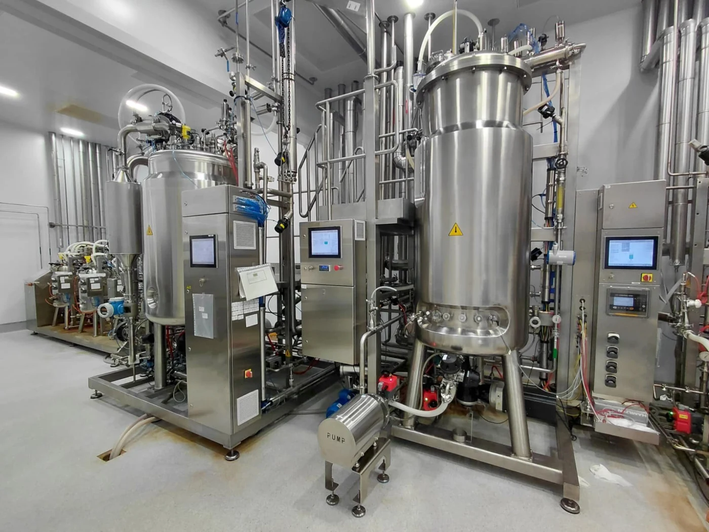 Bioreactors with flexible tubing and filtration equipment in a vaccine production facility